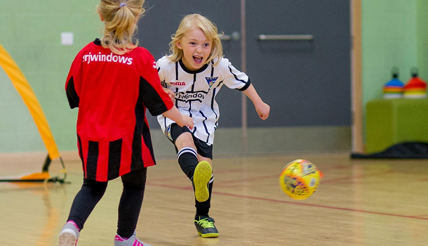 Two girls playing football